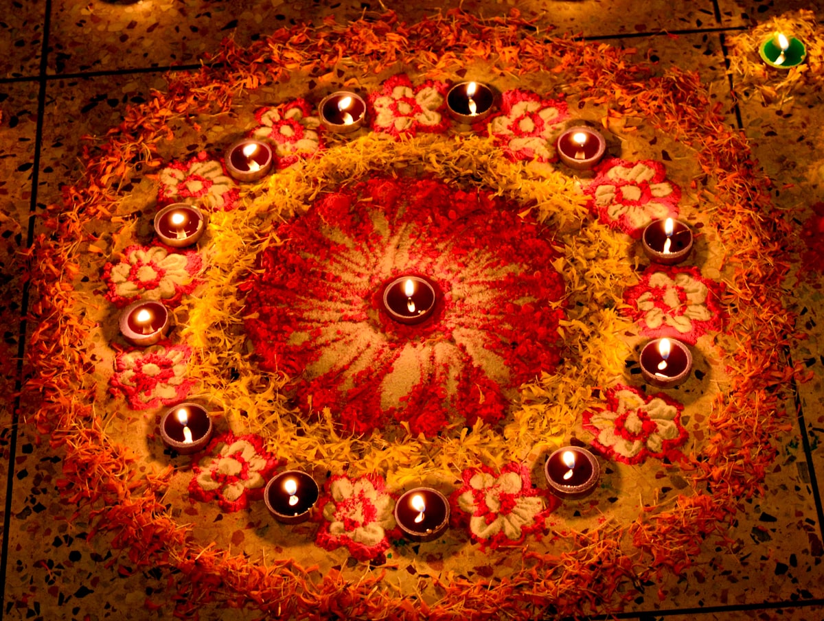 Circular rangoli of Diwali diyas + flowers — traditional home decoration 2026