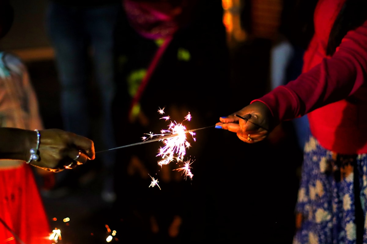 Indian family lighting Diwali sparklers together — Deepavali NRI celebration 2026